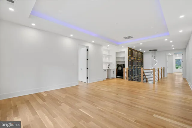 a view of an empty room with wooden floor