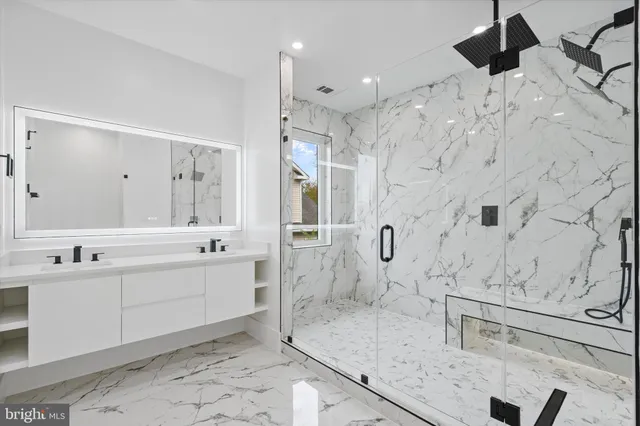 a large bathroom with a granite countertop sink mirror and shower
