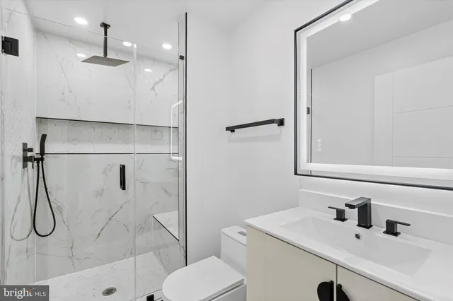 a bathroom with a sink toilet and shower