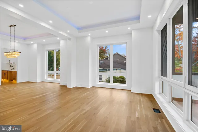 a view of an empty room with glass door and balcony