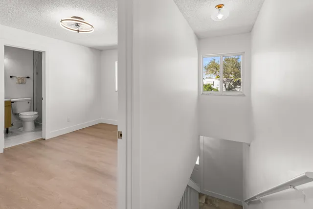 an aerial view of residential houses with outdoor space and trees