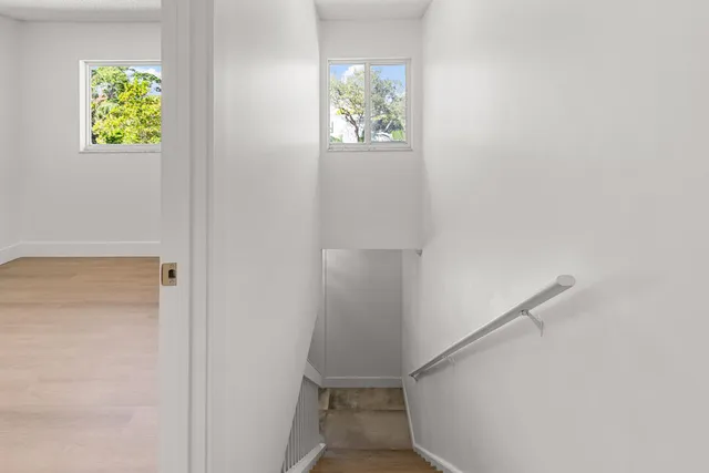 a hallway with a book shelf in it