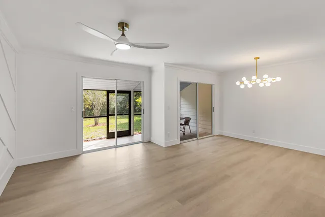 a kitchen with refrigerator cabinets and wooden floor