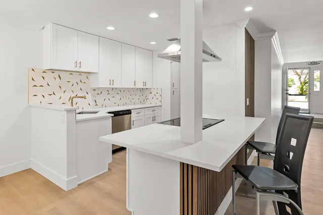 a kitchen with a sink stove and refrigerator