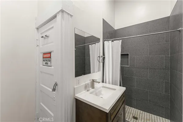 a bathroom with a sink a mirror and a shower