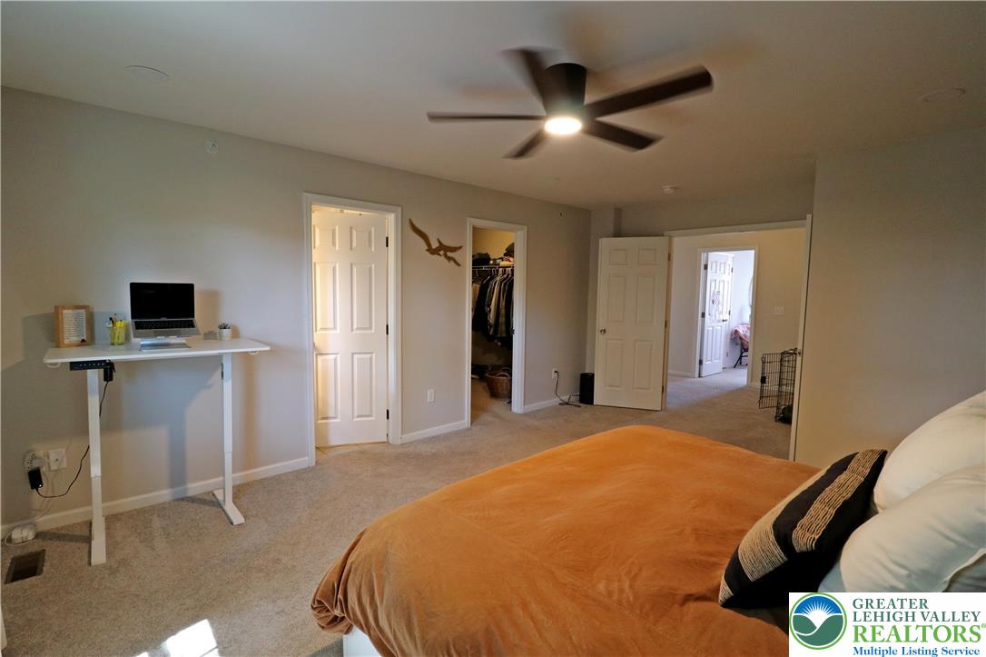4502 Benjamin Court Emmaus, PA 18049 - Photo 27 of 53 A well-lit bedroom with soft carpet offers a private workspace and ample closet space.
