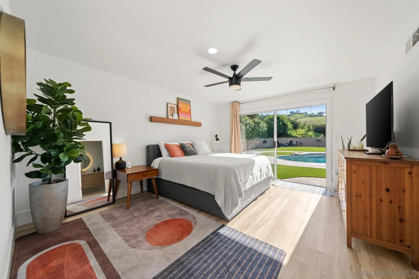 4010 Corral Canyon Road Bonita, CA 91902 - Photo 16 of 35 a spacious bedroom with a bed and a flat screen tv