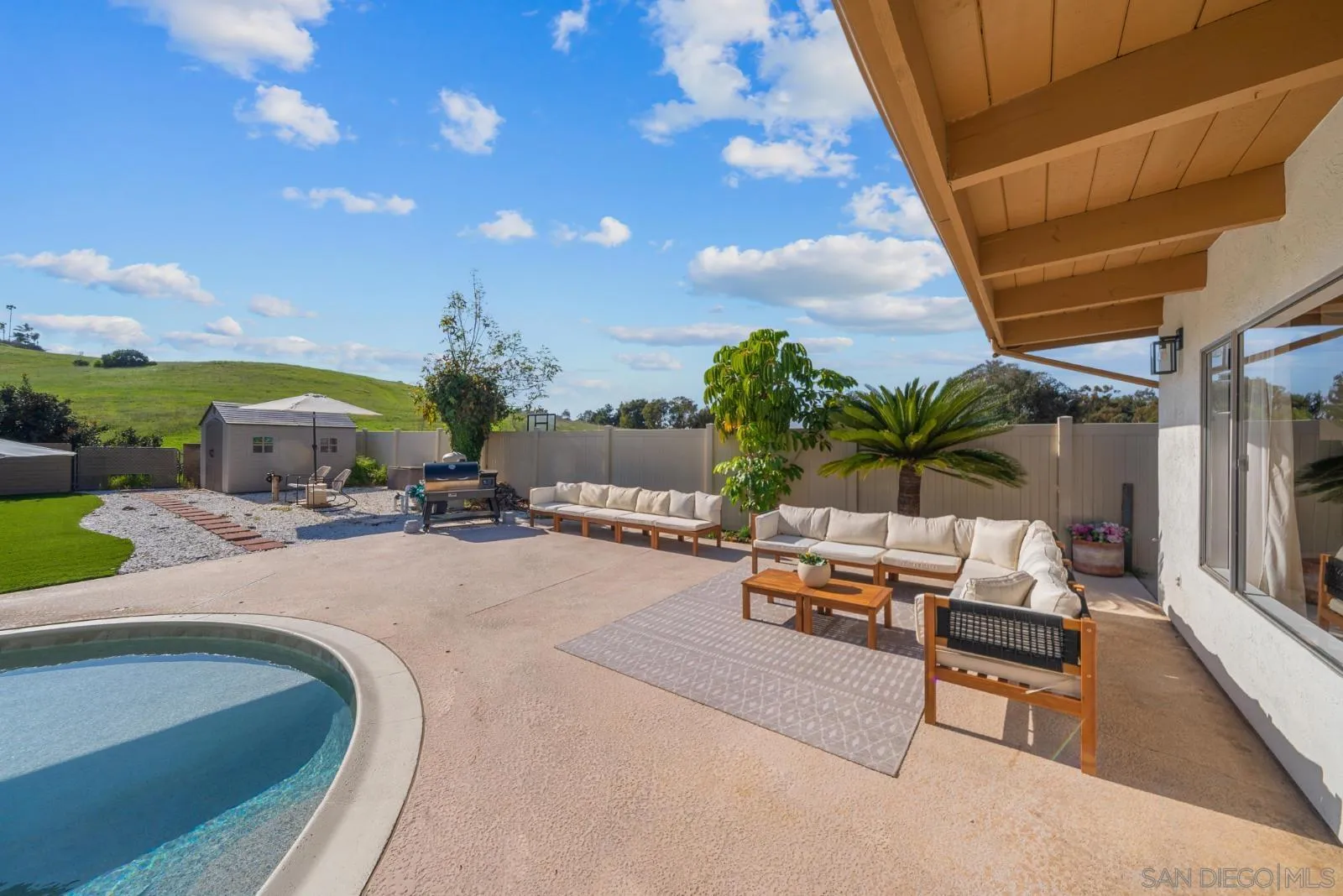 4010 Corral Canyon Road Bonita, CA 91902 - Photo 26 of 35 a swimming pool with outdoor seating and a garden