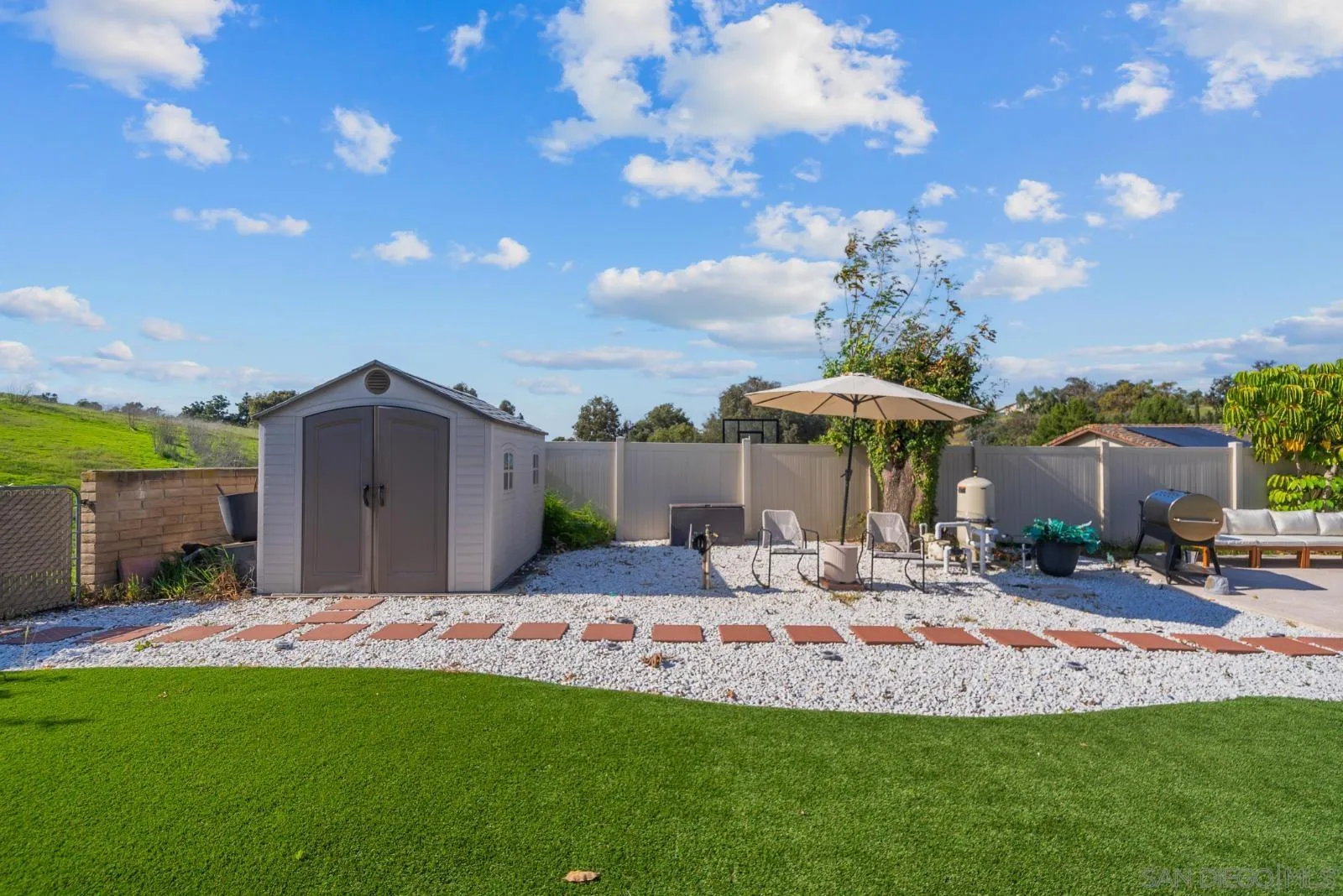 4010 Corral Canyon Road Bonita, CA 91902 - Photo 29 of 35 a front view of a house with a yard fountain and outdoor seating