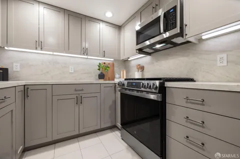 a kitchen with stainless steel appliances granite countertop cabinets and window
