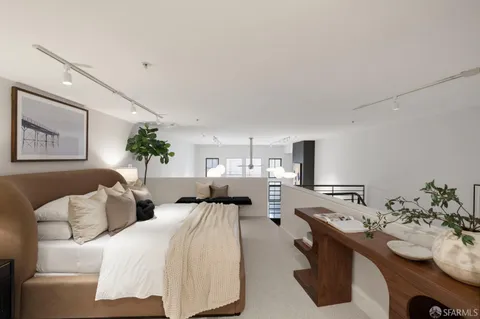 a living room with couches and painting on the wall
