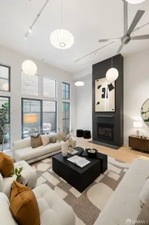 a living room with furniture fireplace and a large window