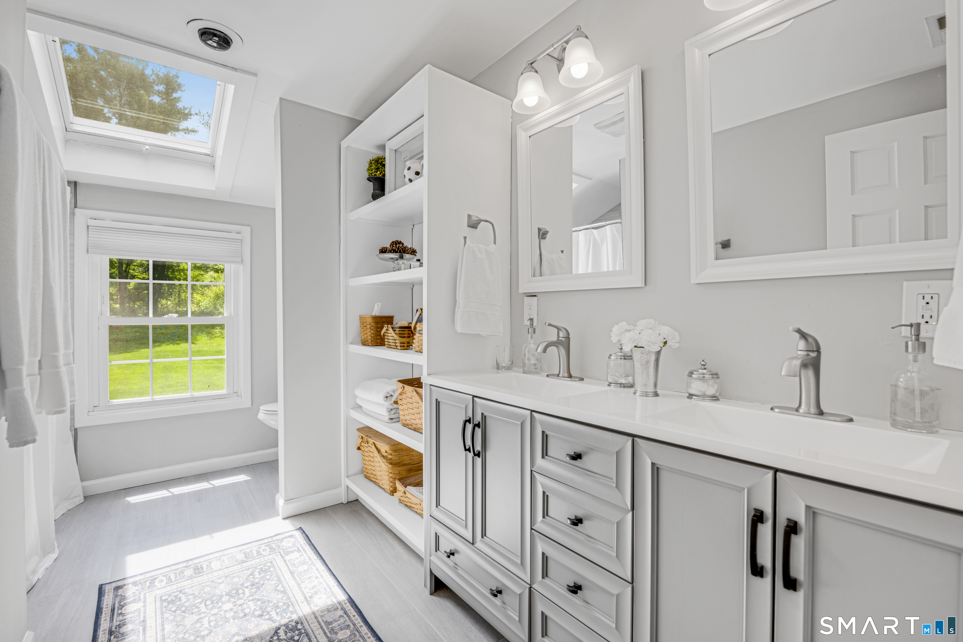 1000 Bassett Road Watertown, CT 06795 - Photo 26 of 35 a spacious bathroom with a granite countertop sink a mirror and a bathtub