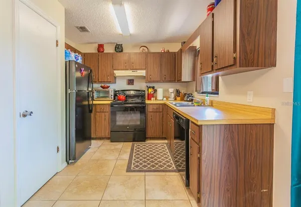 a kitchen with stainless steel appliances a refrigerator sink and cabinets