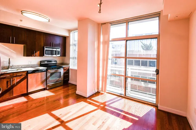 a kitchen with a sink stove and microwave