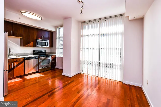 a view of a balcony with wooden floor and fence