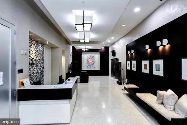 a lobby with furniture and potted plants