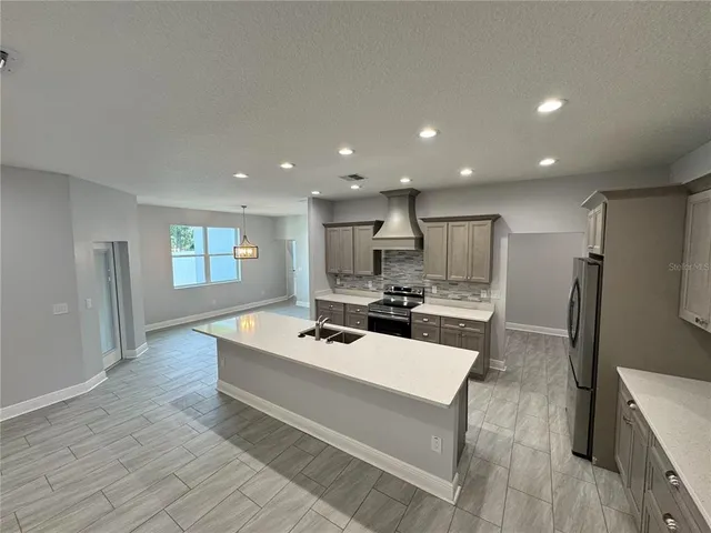 a kitchen with a sink and refrigerator