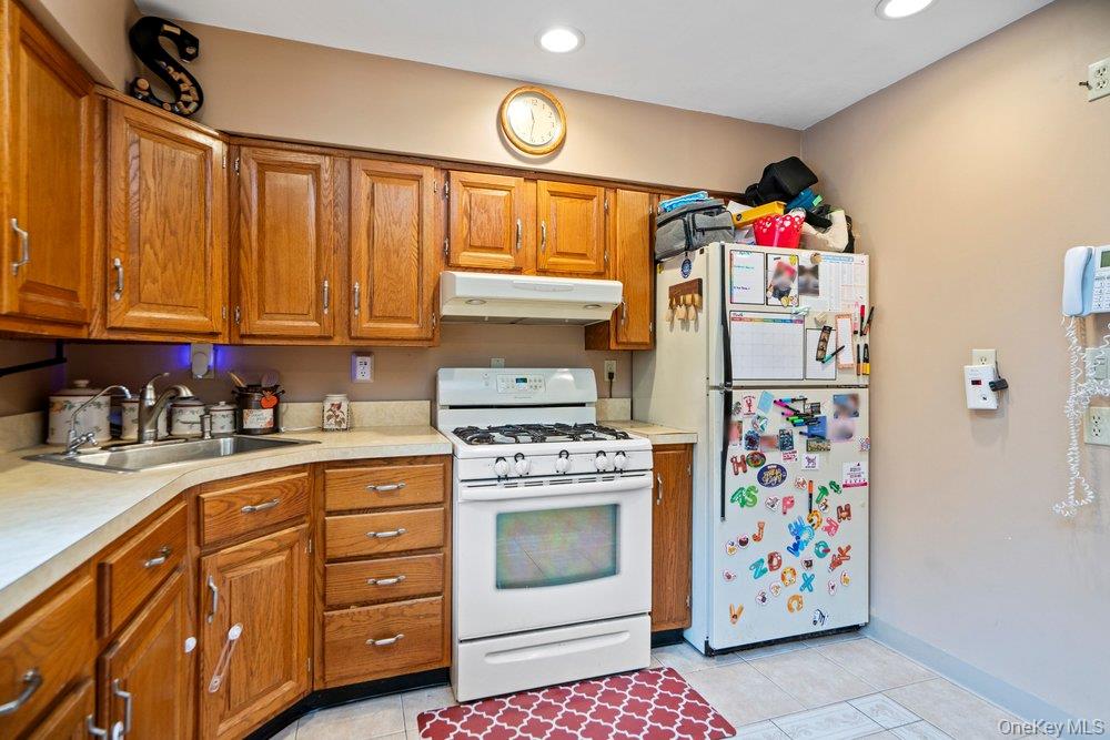 101 Sexton Road West Babylon, NY 11704 - Photo 16 of 33 a kitchen with refrigerator and cabinets