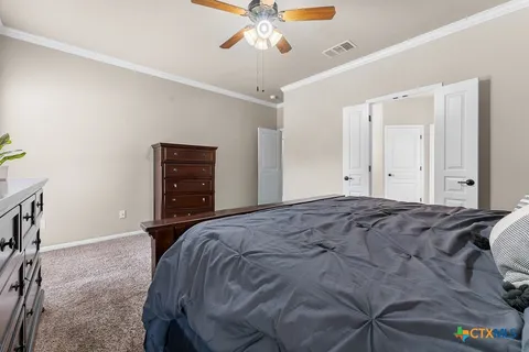 a bedroom with a bed and a chandelier