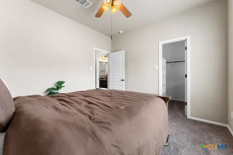 a bedroom with a bed and a chandelier