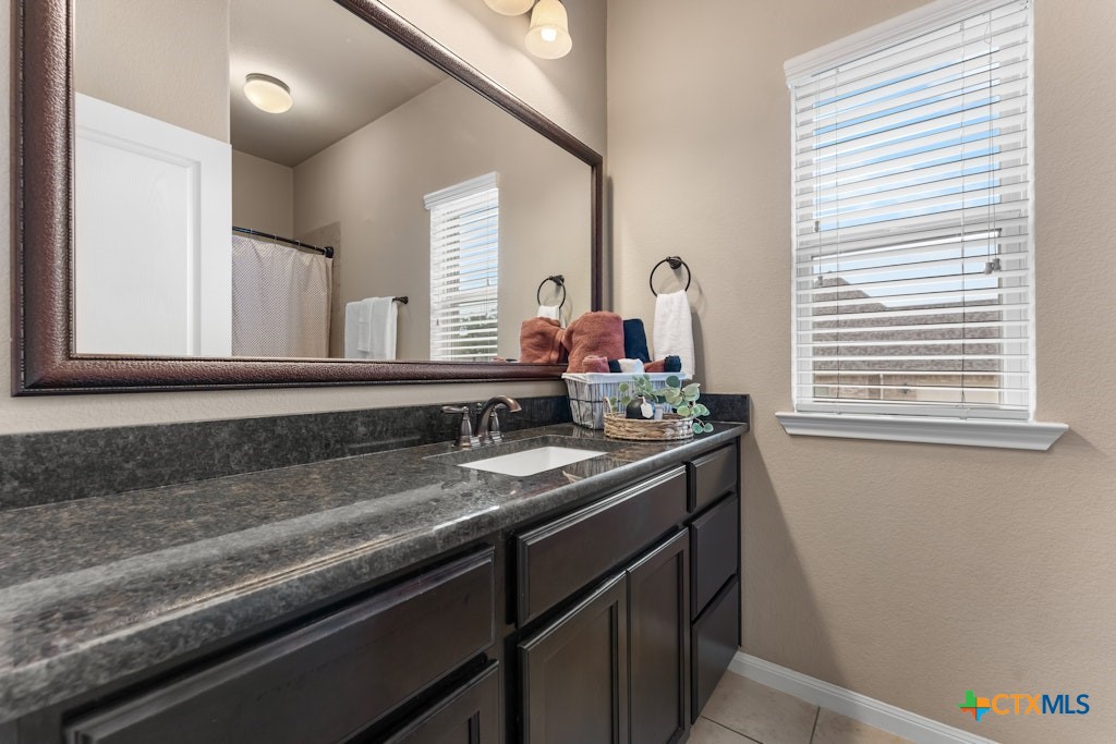 430 Archstone Loop Belton, TX 76513 - Photo 23 of 40 a bathroom with a granite countertop sink and a mirror