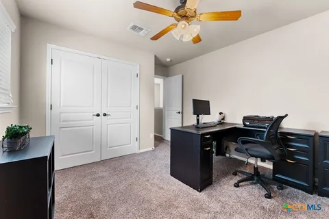 a kitchen with a stove top oven and cabinets