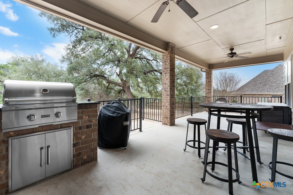 430 Archstone Loop Belton, TX 76513 - Photo 32 of 40 a kitchen with a stove a refrigerator and chairs