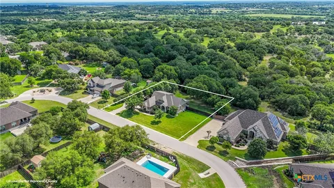 an aerial view of a house with a garden