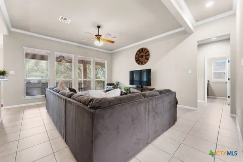 a living room with furniture and a open kitchen