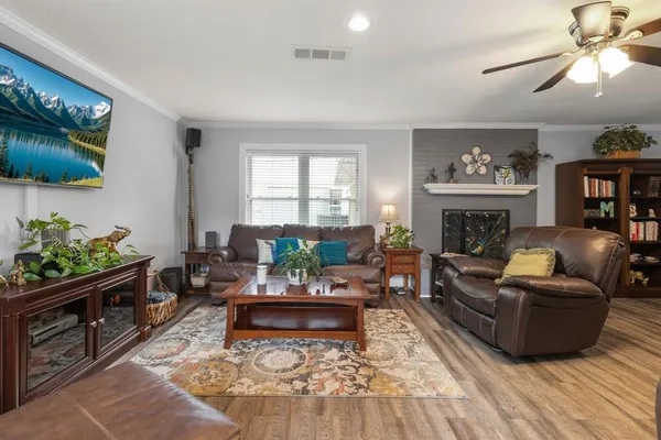 a living room with furniture and a fireplace