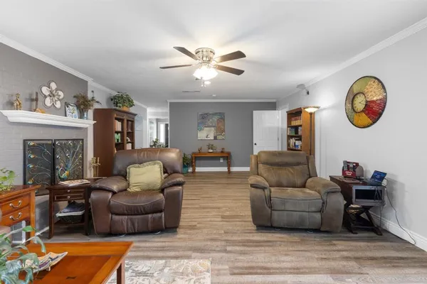 a living room with furniture and a chandelier