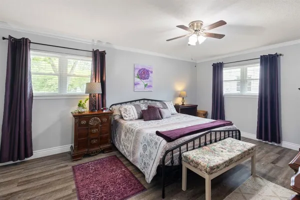 a bedroom with a bed and a chandelier