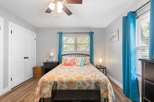 a bedroom with a bed and wooden floor
