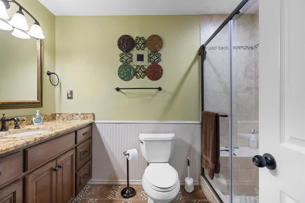 a bathroom with a toilet sink and mirror