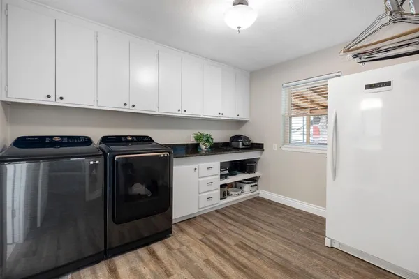 a kitchen with granite countertop a stove and cabinets