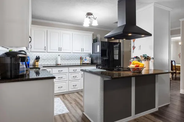 a kitchen with stainless steel appliances granite countertop a sink and cabinets