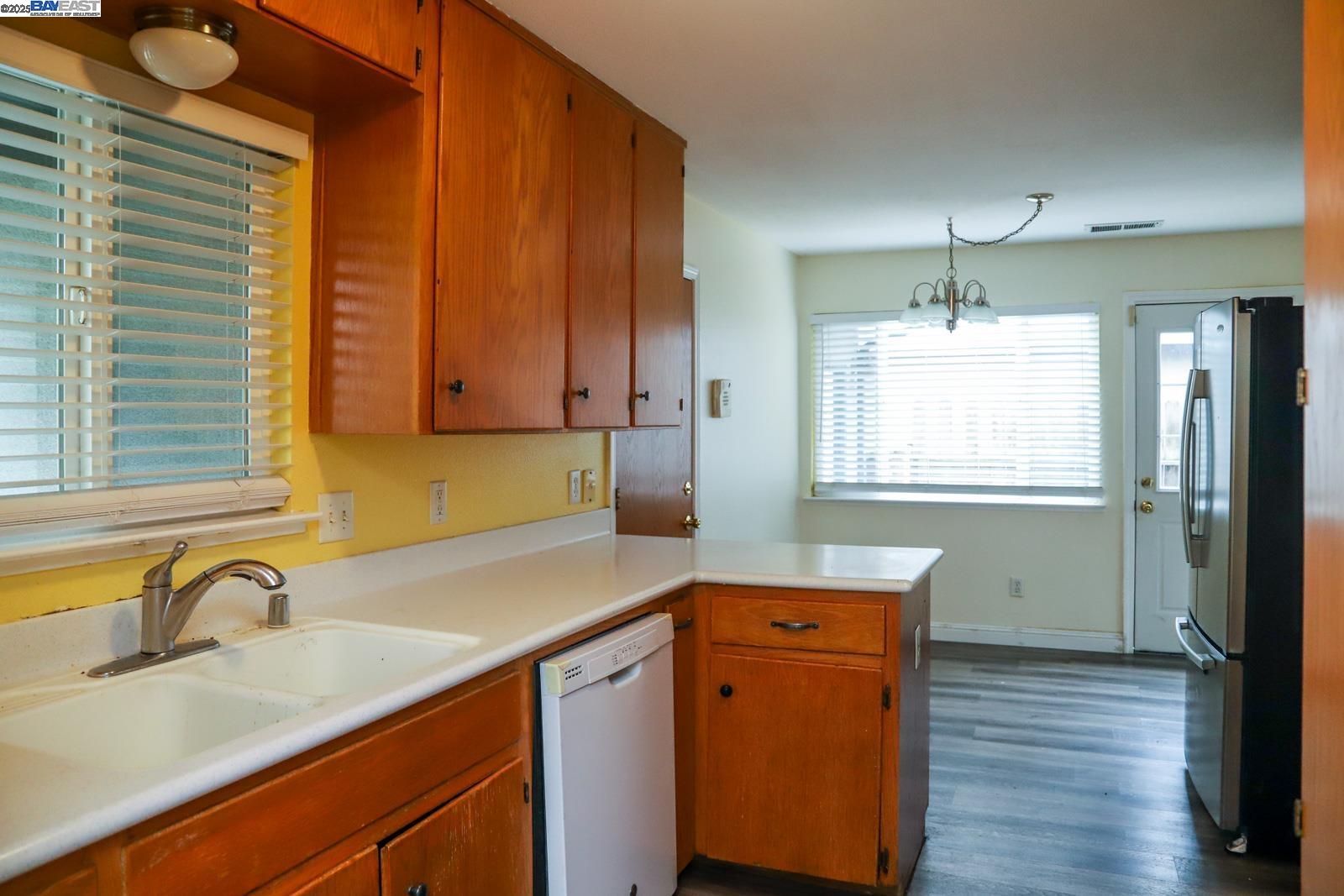 4295 North Archie Avenue Fresno, CA 93726 - Photo 13 of 23 a kitchen with a sink cabinets and wooden floor