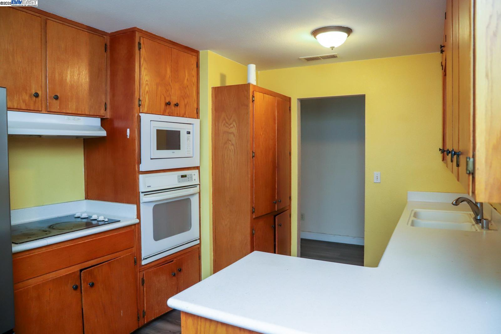 4295 North Archie Avenue Fresno, CA 93726 - Photo 14 of 23 a kitchen with stainless steel appliances granite countertop a refrigerator and a stove top oven