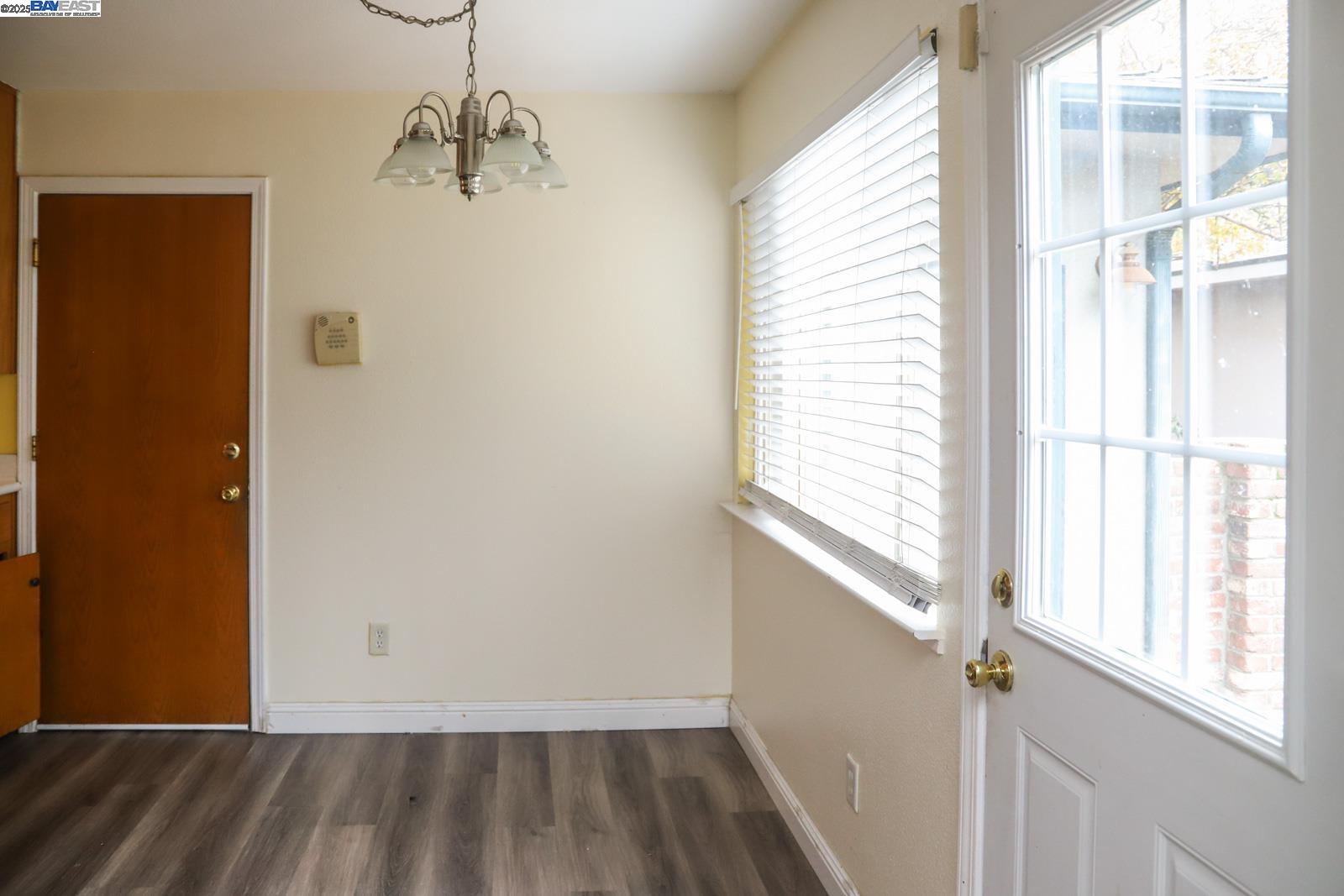 4295 North Archie Avenue Fresno, CA 93726 - Photo 17 of 23 a view of a room with wooden floor and windows