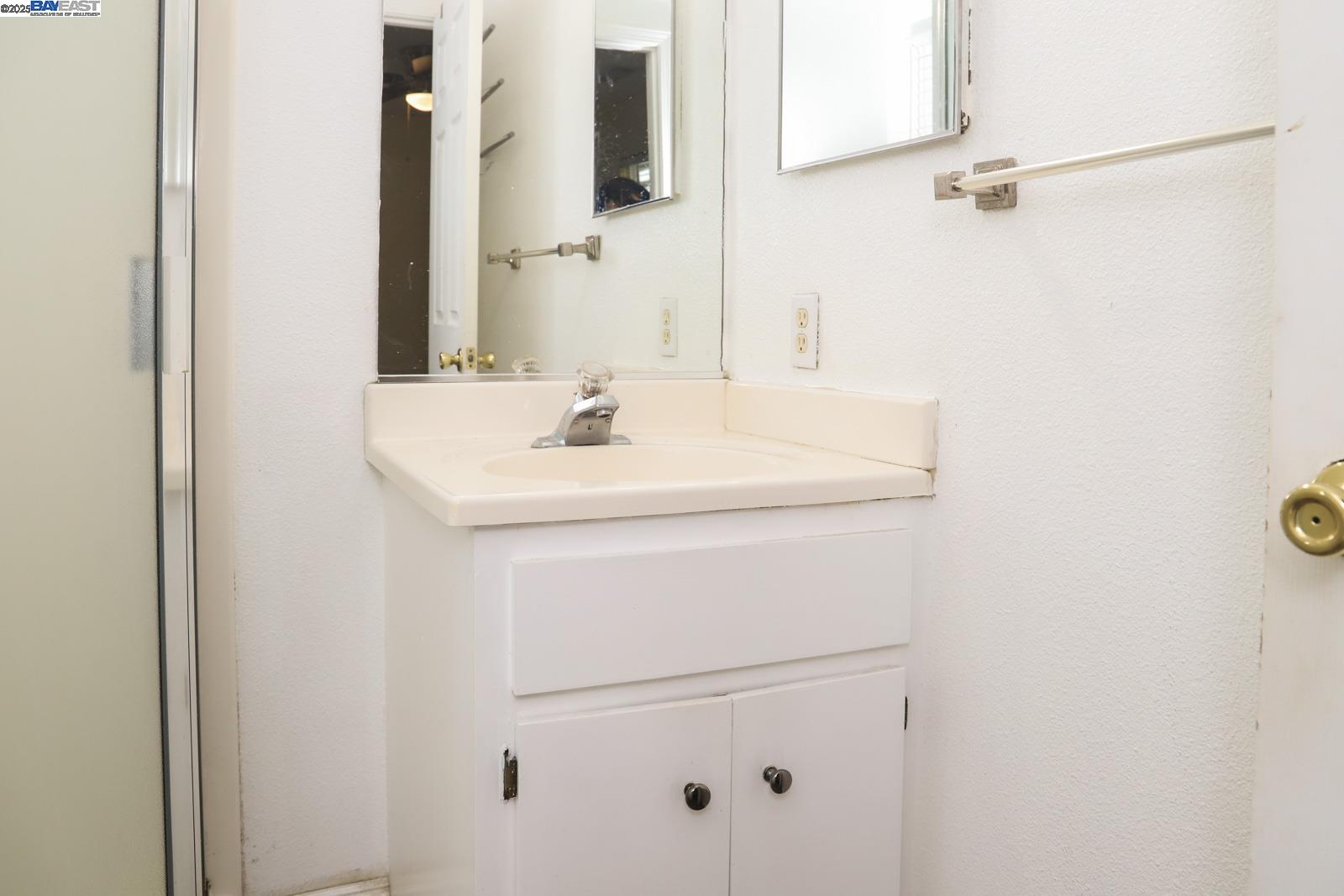 4295 North Archie Avenue Fresno, CA 93726 - Photo 10 of 23 a bathroom with a sink and a mirror