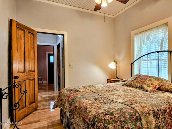 a bedroom with a bed and a chandelier