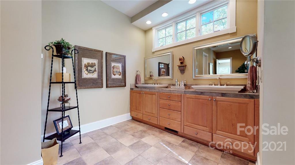 1755 St Johns Church Road Concord, NC 28025 - Photo 24 of 41 a spacious bathroom with a granite countertop sink and a mirror