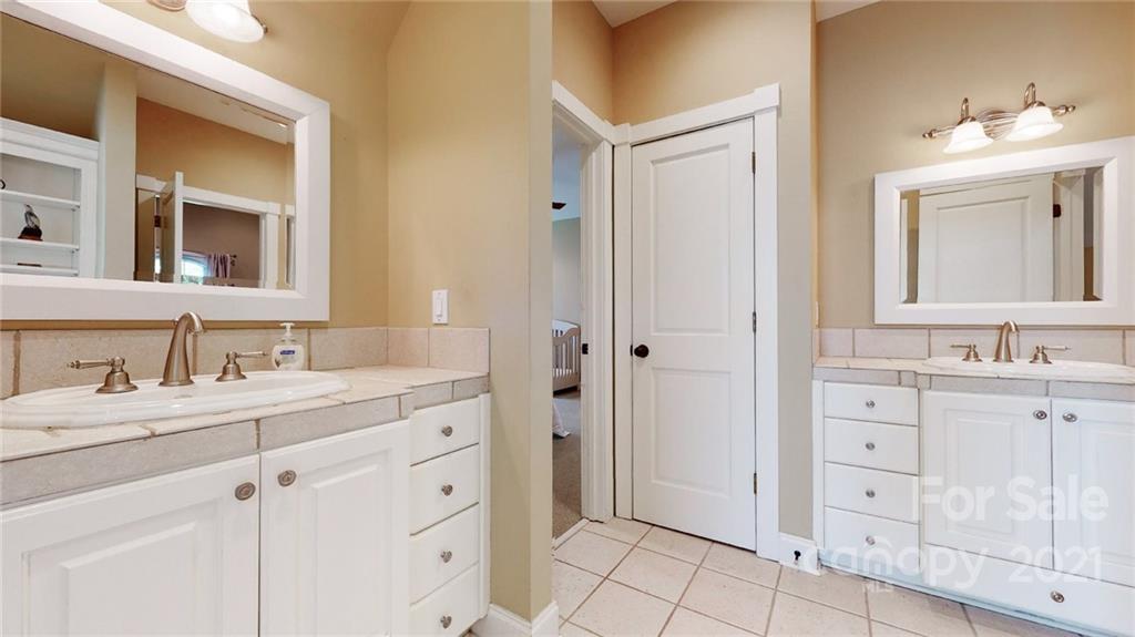 1755 St Johns Church Road Concord, NC 28025 - Photo 34 of 41 a bathroom with a granite countertop sink mirror and