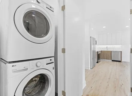 a view of a hallway with washer and dryer