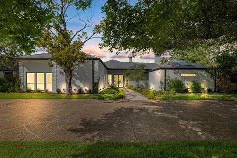 a view of a house with a garden and pathway