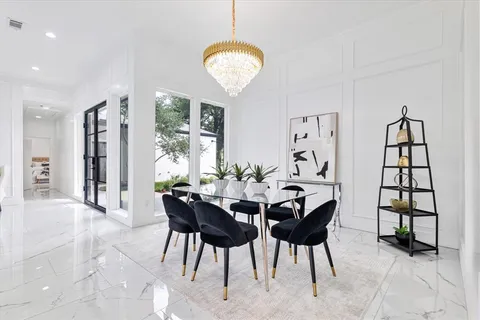 a view of a dining room with furniture and a large window