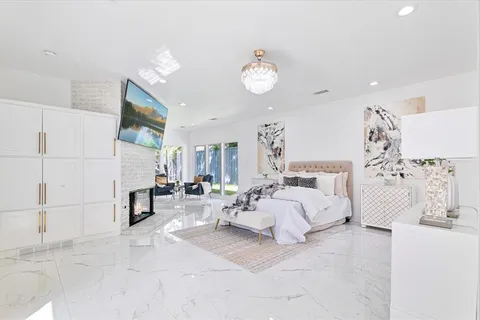 a spacious bedroom with a bed and a couch