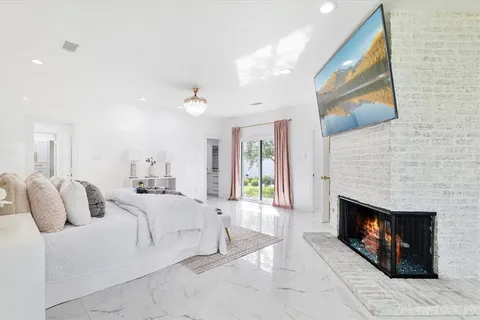 a spacious bedroom with a bed and a fireplace