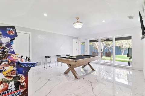 a kitchen with a stove a refrigerator a sink a dining table and chairs